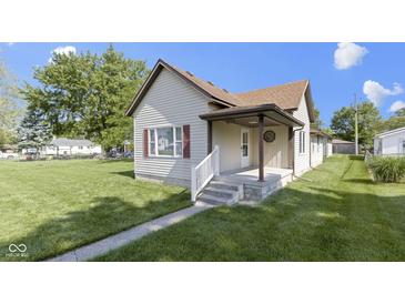 Charming home featuring a cozy front porch, well-kept lawn, and classic architectural details at 310 W Jackson St, Alexandria, IN 46001