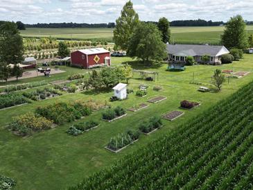 Expansive property with garden, barn, and charming home in a serene, rural setting with lush landscape at 3840 W 38Th St, Anderson, IN 46011