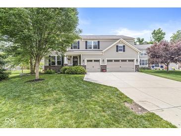 Charming two-story home featuring a three-car garage and a well-manicured front lawn at 4642 Big Run Ct, Indianapolis, IN 46239