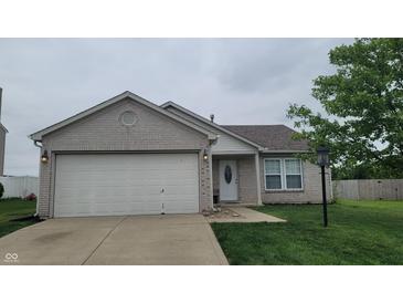 Charming single-story home featuring a two-car garage and a well-maintained front yard at 713 Driftwood Cir, Danville, IN 46122