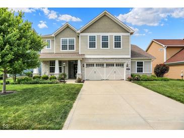 Charming two-story home with a stone facade, well-manicured lawn, and an inviting front entrance at 848 Silverheels Dr, Westfield, IN 46074