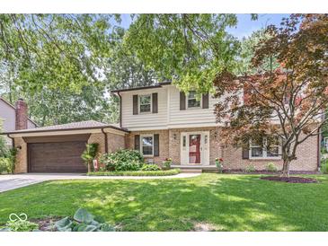 Charming two-story home with a well-manicured lawn and mature trees at 9221 Holyoke Ct, Indianapolis, IN 46268