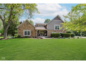 Charming home with stone accents, manicured lawn, and inviting front porch at 102 Roxbury Ln, Noblesville, IN 46062