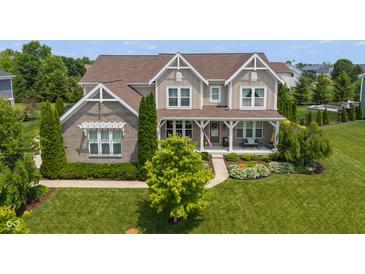 Charming two-story home with a well-manicured lawn, beautiful landscaping, and inviting front porch at 1102 Clearwell Dr, Greenwood, IN 46143