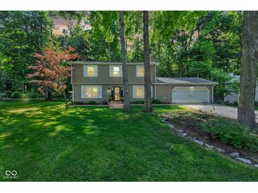 Charming two-story home with attached two-car garage and a lush green front yard at 11510 Ralston Ave, Carmel, IN 46032