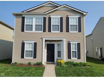 Charming two-story home with a manicured lawn, black shutters, and neutral siding at 12671 Endurance Dr, Fishers, IN 46037
