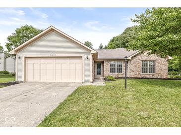 Charming single-story home featuring a brick facade, attached garage, and well-maintained lawn at 1631 Wilford Ln, Indianapolis, IN 46229