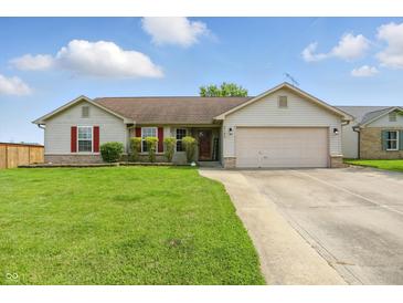 Charming single-story home with a well-manicured lawn and a two-car garage at 2145 W Autumn Ln, Columbus, IN 47201
