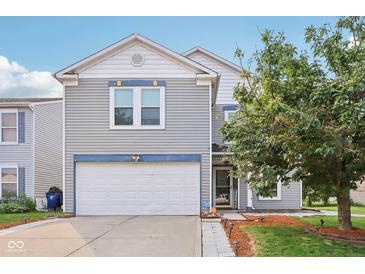 Charming two-story home with a two-car garage, well-maintained lawn, and inviting curb appeal at 2887 Ludwig Dr, Indianapolis, IN 46239