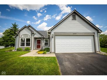 Charming one story home featuring a two car garage, neat landscaping and a red front door at 2905 Inverrary Ct, Indianapolis, IN 46234
