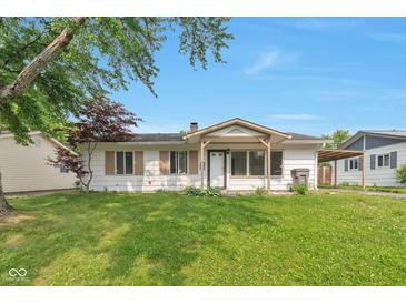 Charming single-story home featuring a well-manicured lawn and inviting covered entry at 3242 Welch Dr, Indianapolis, IN 46224