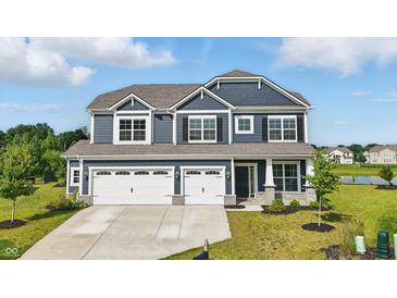 Beautiful two-story home with a three-car garage and manicured lawn, perfect for Gathering living at 6762 Brentwood Ct, Brownsburg, IN 46112