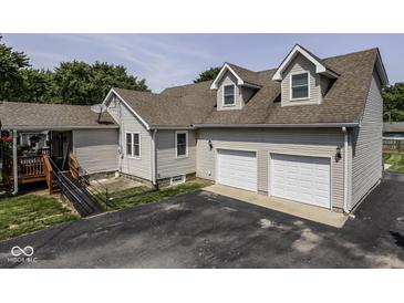 Charming home featuring a two-car garage, dormer windows and neutral-toned siding at 730 N Forsythe St, Franklin, IN 46131