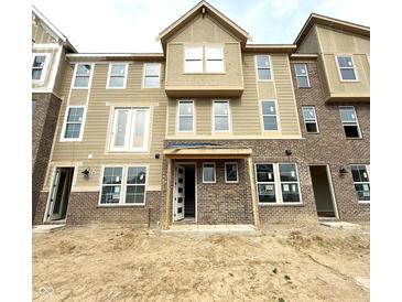 New construction townhome showing brick and siding facade and covered entry at 7305 Bayview Run # 13-605, McCordsville, IN 46055