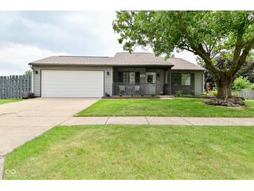 Charming one-story home featuring a two-car garage, inviting porch, and well-maintained lawn at 1219 Citation W Cir, Lebanon, IN 46052