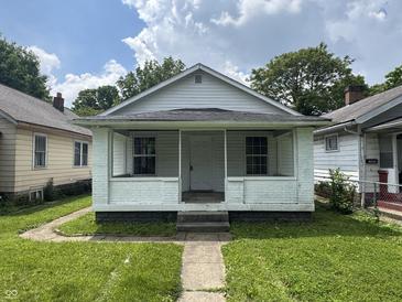 Charming home with a covered front porch and a well-manicured lawn at 1445 W 34Th St, Indianapolis, IN 46208