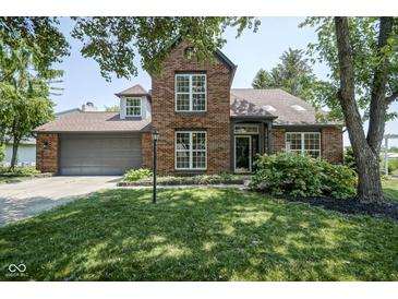 Beautiful brick home with a manicured lawn, mature trees, and an attached two-car garage at 17635 Willow Creek Way, Westfield, IN 46074