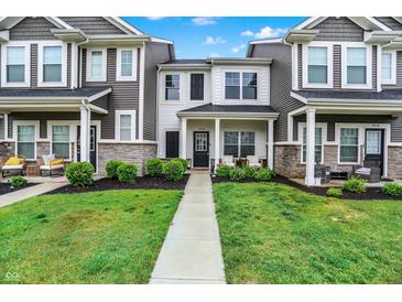 Charming townhome with manicured lawn and inviting front porch, perfect for relaxing outdoors at 3428 Thomas Jefferson St, Westfield, IN 46074