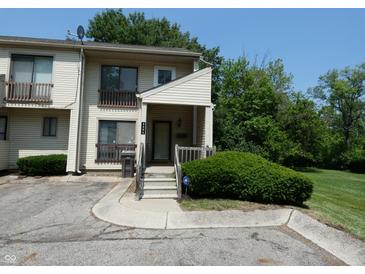 Charming two-story townhome with a cozy front porch and well-maintained landscaping at 4486 Abby Creek Ln, Indianapolis, IN 46205