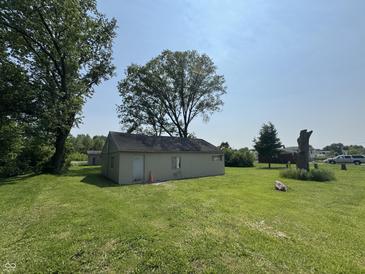 The exterior features a small structure with lawn and trees surrounding it at 5159 E Edgewood Ave, Indianapolis, IN 46237
