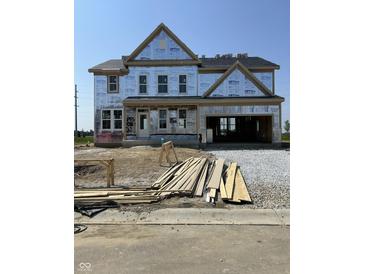 New home in progress featuring two-car garage, gable roof, and ample windows, awaiting completion at 637 Firefly Ct, Greenfield, IN 46140