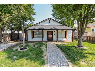 Charming single-story home with a gravel path and lush green lawn, framed by mature trees at 110 Highland Ave, Franklin, IN 46131