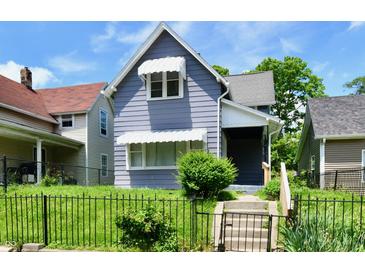 Charming two-story home featuring a well-maintained lawn and decorative awnings at 1346 W 27Th St, Indianapolis, IN 46208