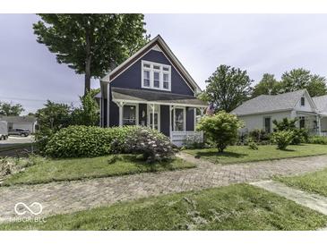Charming two-story home with a well-manicured front yard, brick driveway, and lovely landscaping at 1393 Wayne St, Noblesville, IN 46060