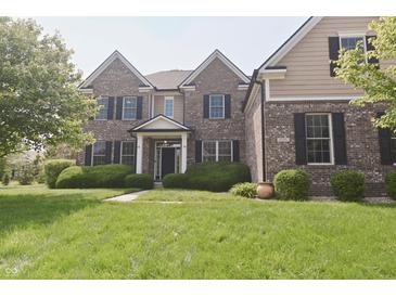 Charming two-story brick home with a well-manicured lawn and neatly trimmed hedges at 15201 Slateford Rd, Noblesville, IN 46062
