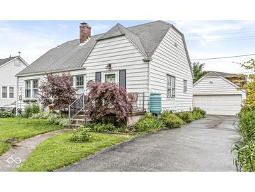 Charming two-story home featuring a landscaped front yard and a detached garage at 1621 Beeler Ave, Speedway, IN 46224