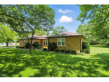 Charming single-story brick home featuring a lush green lawn and mature trees at 1914 S Avon Ave, Avon, IN 46123
