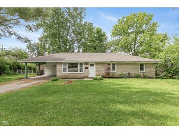 Charming ranch-style home with a well-maintained lawn and a covered carport at 3225 25Th St, Columbus, IN 47203