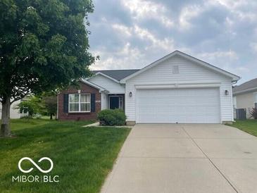 Ranch home with a brick accent, a two-car garage, and a well-manicured lawn at 3861 Indigo Blue Blvd, Whitestown, IN 46075