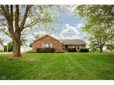 Charming brick ranch home featuring a well-manicured lawn and mature trees at 4901 E County Road 100 N, Avon, IN 46123