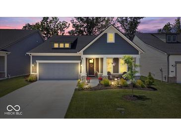 Charming single-Gathering home featuring a gray color scheme, well-manicured lawn, and attached garage at 7154 Covington St, Lebanon, IN 46052