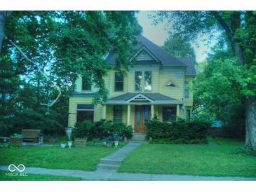 Charming two-story home with a well-manicured lawn and inviting front porch at 783 Woodruff Place Middle Dr, Indianapolis, IN 46201