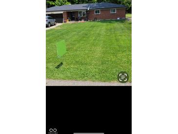 Charming brick ranch-style home with a well-maintained front yard at 8990 N 850 W, Fairland, IN 46126