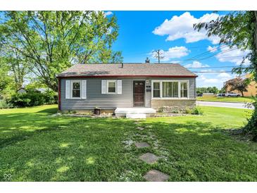 Charming one-story home with a well-maintained front yard and stone walkway at 11 14Th St, Franklin, IN 46131
