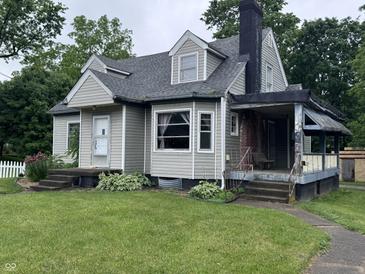 Charming single-Gathering home with gray siding, a chimney, and a well-manicured lawn at 114 S Green St, Brownsburg, IN 46112