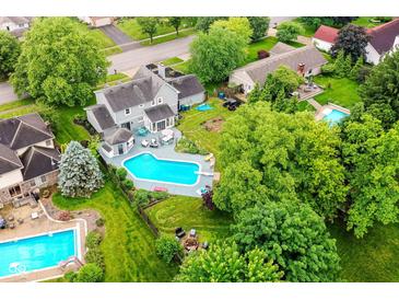 Aerial view of a home with a beautiful pool and backyard area, perfect for outdoor relaxation at 164 Wellington Pkwy, Noblesville, IN 46060
