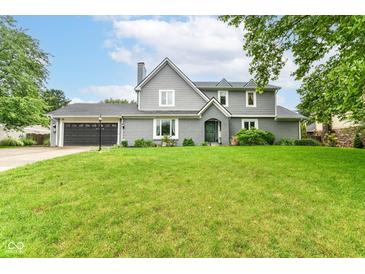 Charming two-story home featuring a well-manicured lawn, attached garage, and inviting front entrance at 164 Wellington Pkwy, Noblesville, IN 46060