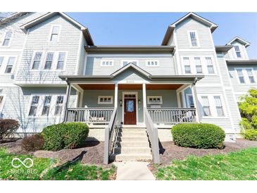 Inviting gray two-story home with covered porch and manicured landscaping at 2230 N Pennsylvania N St # 7, Indianapolis, IN 46205