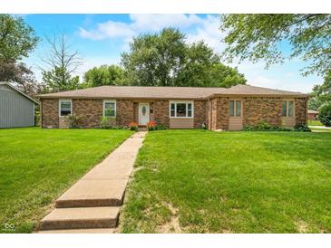Charming brick ranch home with a well-manicured lawn and inviting walkway at 3210 Flintwood Dr, Columbus, IN 47203
