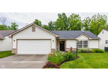 Charming single-story home with a well-manicured lawn and attached garage, perfect for suburban living at 4103 Caddy Way, Indianapolis, IN 46268