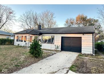 Charming single-story home with a well-maintained lawn and an attached garage at 4108 Patricia St, Indianapolis, IN 46222