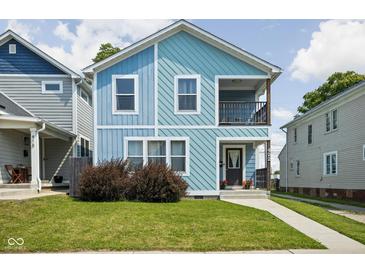 Charming two-story home with light blue siding, a small porch, and a well-maintained front yard at 422 Sanders St, Indianapolis, IN 46225