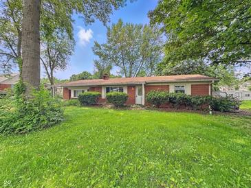 Charming brick ranch home with a well-maintained lawn and mature trees at 5240 Southdale Dr, Indianapolis, IN 46217