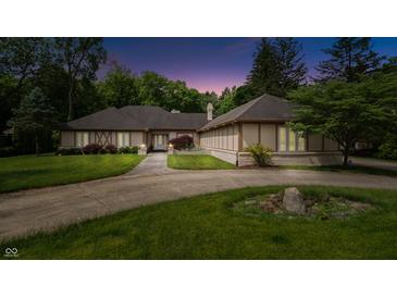 Stunning front exterior with a curved driveway, manicured lawn, and a home with unique architectural details at 7554 Silverpine Ct, Indianapolis, IN 46250