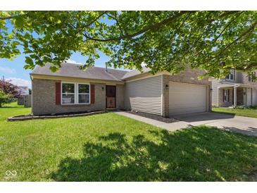 Charming one-story brick home with a well-maintained lawn and attached garage at 8447 Wanda Lake Dr, Camby, IN 46113