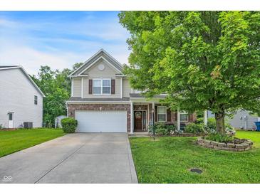 Charming two-story home featuring a well-manicured lawn, two-car garage and beautiful brick and siding details at 9605 Treyburn Green Way, Indianapolis, IN 46239